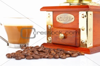 Cup, grinder, coffee pot and beans