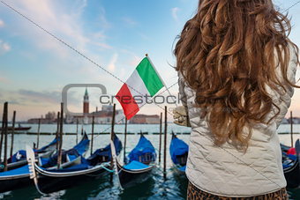 Closeup on Italian flag in hands of woman traveler in Venice
