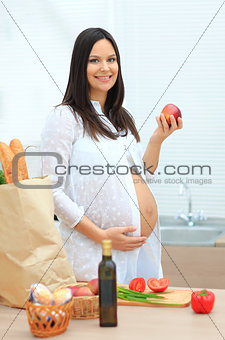 Pregnant woman eating the apple