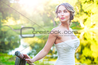 Stylish Young Bride Outdoors at Green Nature Background. Toned Photo.