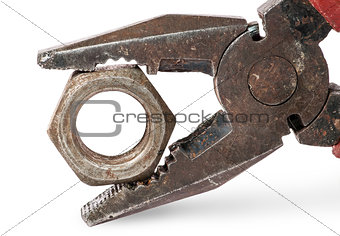 Closeup of old pliers and nut