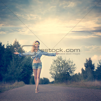 Beautiful Woman with Open Arms under the Sunrise