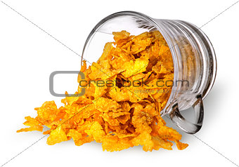 Cornflakes spill out of a glass cup