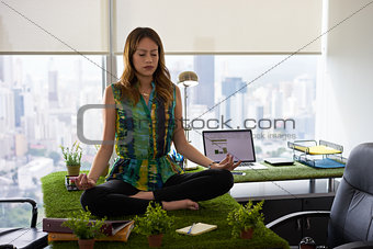 Business Woman Doing Yoga Meditation On Table In Office