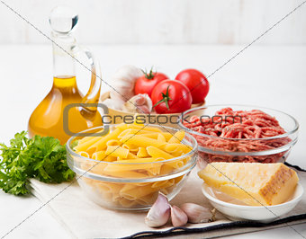 Italian food ingredients: pasta, tomatoes, herbs, minced