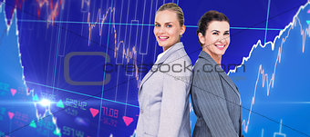 Composite image of attractive businesswomen standing back-to-back