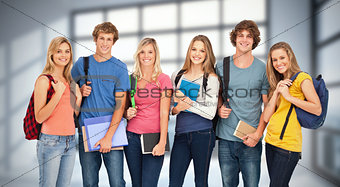 Composite image of smiling students wearing backpacks and holding books in their hands