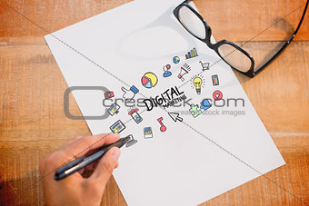Composite image of left hand writing on white page on working desk