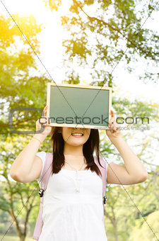 Asian college student with blank chalkboard