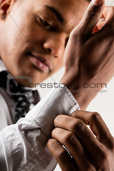 elegant black man adjusting cuff