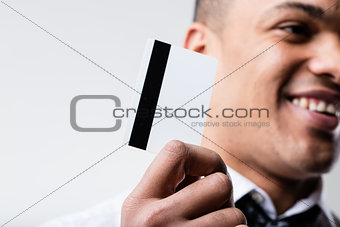 black man with blank credit card on foreground