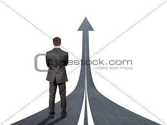 Businessman standing on road going up llike arrow