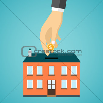 businessman hand putting coin inside the house.