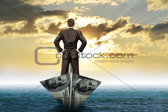 Businessman in dollar boat