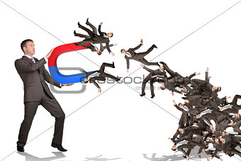Businessman catching people on magnet