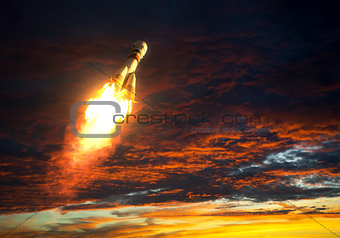 Carrier Rocket Takes Off On A Background Of Red Clouds