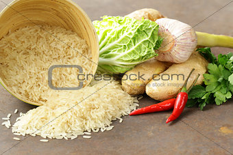 Asian food - rice, ginger, chili pepper on a stone background