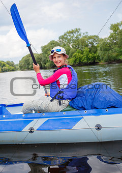 Girl with paddle and kayak