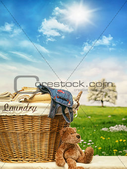 Laundry basket with clothes against a blue sky