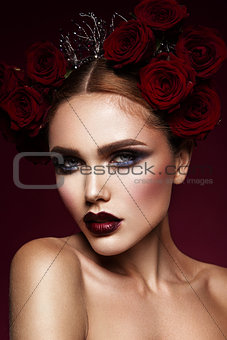 Beauty fashion model girl with dark makeup and roses in her hair