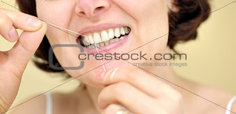 Woman flossing her teeth 