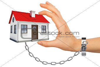 Chained hand holding house