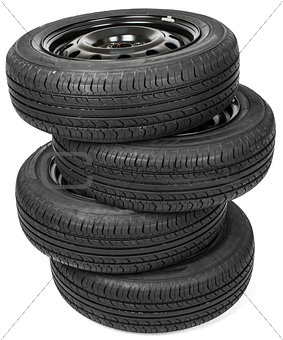 Stack of four wheel black tyres for summer