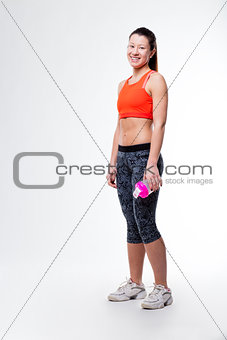 smiling gym dressed woman with her bottle