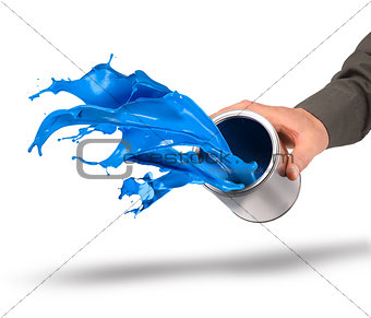 Hand throwing blue paint from can