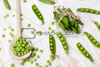 Green peas on wooden desk.