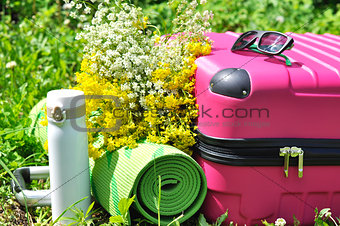 Suitcase with thermos and yoga mat
