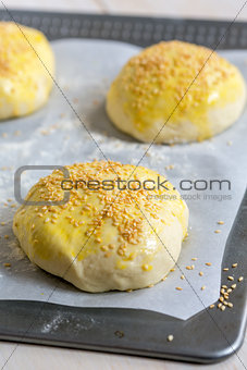 Billets dough for baking buns with sesame seeds.