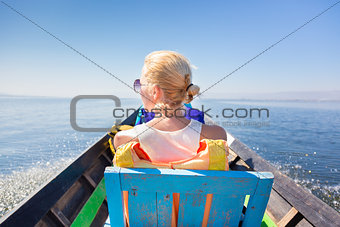 Female tourist travels by traditional boat.