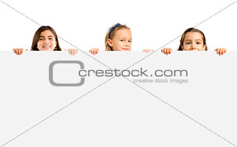 Little girls holding a white board