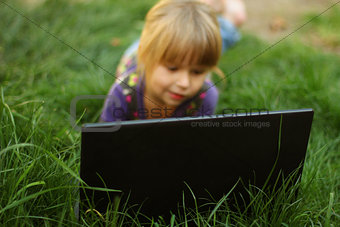 beautiful little girl with a laptop