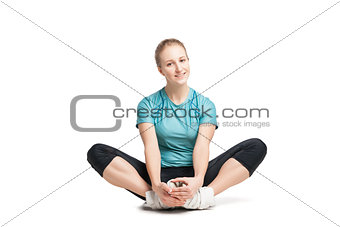 Beautiful sporty woman sitting on the floor