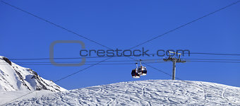 Panoramic view on gondola lift and ski slope