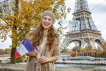 woman showing flag on embankment near Eiffel tower, Paris