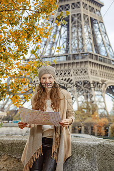 tourist woman on embankment near Eiffel tower in Paris with map