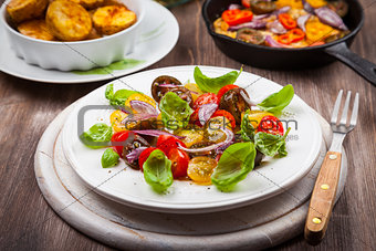 Tomato salad with grilled cheese and baked potatoes