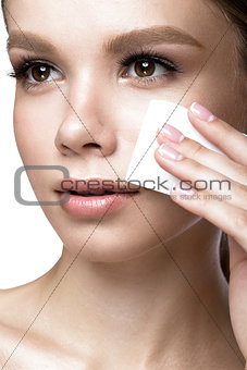 Beautiful young girl with wipes for removing makeup and French manicure. Beauty face.