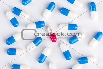 Blue capsules around pink capsule