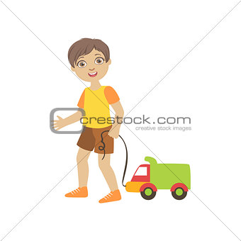 Boy Walking Dragging Toy Truck On A String