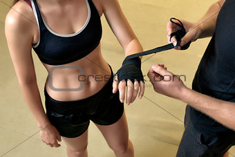 Young woman training in the gym with trainer