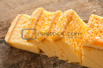 Close up of yellow cake with sprinkles and icing