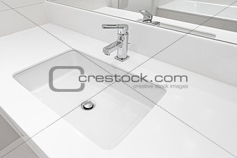 White sink by the mirror.