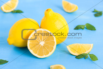 Lemon on the blue wood table with mint