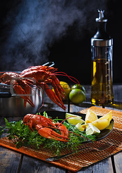 Crayfish with greens and a citrus on  table from old boards