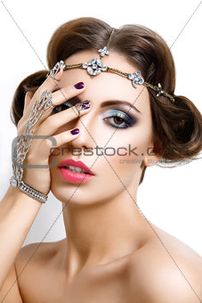 Beautiful girl with make-up and jewelry