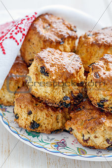 Homemade scones with dried berries and white napkin.